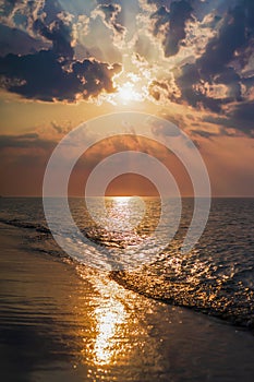 The concept of travel and rest at the seaside, sea waves on the background of the shoreline and sunset