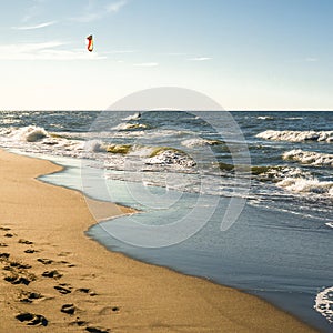 The concept of travel and rest at the seaside, sea waves on the background of the shoreline and sunset