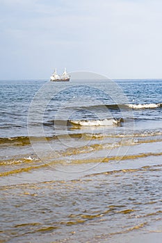 The concept of travel and rest at the seaside, sea waves on the background of the shoreline and sunset