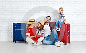 Concept travel and tourism. happy family with suitcases near w