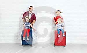 Concept travel and tourism. happy family with suitcases near w