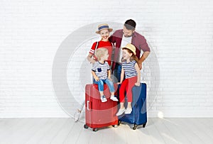 Concept travel and tourism. happy family with suitcases near w