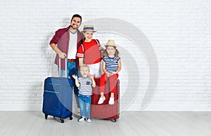 Concept travel and tourism. happy family with suitcases near w