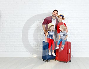 Concept travel and tourism. happy family with suitcases near w