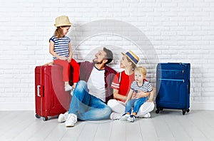 Concept travel and tourism. happy family with suitcases near w