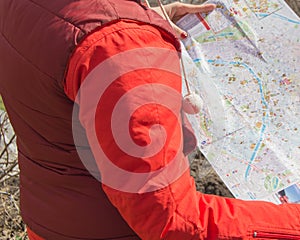 The concept of travel and tourism, location and orienteering. Close-up of a woman looking at a map