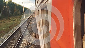 Concept travel train wagon journey. View through the train window of the wagons in the composition passing nature