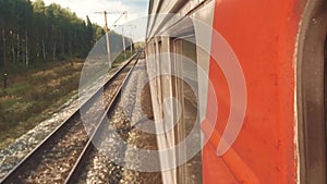 Concept travel train wagon journey. View through the train window of the wagons in the composition passing nature