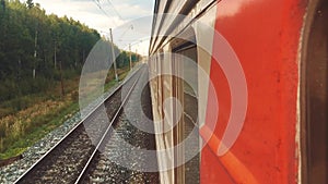 Concept travel train wagon journey. View through the train window of the wagons in the composition passing nature