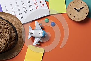 Concept of travel vacation trip and long summer weekend planning on orange or colorful table background