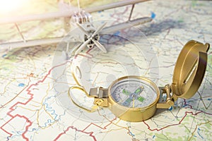 Concept travel. a vintage compass on the map and an airplane