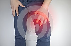 A man suffers from hip pain. The concept of treating a hip joint for trauma, plantation or osteoarthritis photo