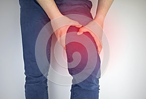 A man suffers from hip pain. The concept of treating a hip joint for trauma, plantation or osteoarthritis photo