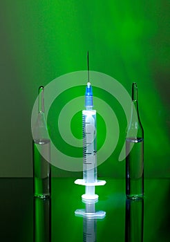 The concept of treatment and prevention. Medical syringe, ampoules for injection. medicines, vaccines, vitamins, painkillers on a