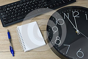 The concept of urgent deadline at work. Keyboard, clock, pen and blank paper