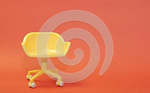 Concept of vacant chair. Yellow stool on orange clean background. Photo in minimal style