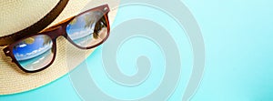 concept vacation and summer travel banner. Happy holidays on sandy tropical sea beach. Panama hat and sunglasses with a reflection