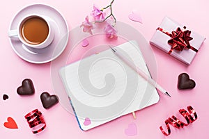 Concept Valentine`s Day. Chocolate candies and coffee, hearts on a pink background. Flat lay copy space. Greeting card