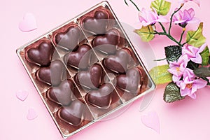 Concept Valentine`s Day. Chocolate candies, hearts on a pink background