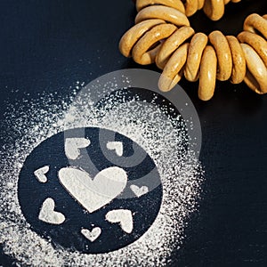 Concept Of Valentine`s Day. Picture of heart of flour on a black background. Happy Valentines Day background