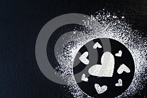 Concept Of Valentine`s Day. Picture of heart of flour on a black background. Happy Valentines Day background. Space for text