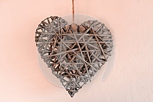 Concept Of Valentine`s Day. Wicker hearts on pink background