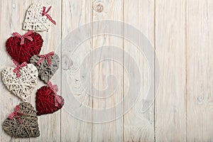 Concept Of Valentine's Day. Wicker hearts on wooden background w