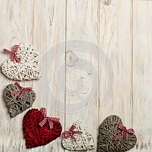 Concept Of Valentine's Day. Wicker hearts on wooden background w