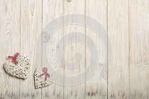 Concept Of Valentine's Day. Wicker hearts on wooden background w