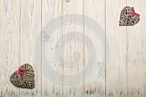 Concept Of Valentine's Day. Wicker hearts on wooden background w