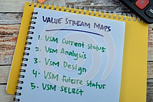 Concept of Value Stream Maps write on book with keywords isolated on Wooden Table