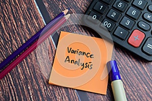 Concept of Variance Analysis write on sticky notes isolated on Wooden Table photo