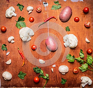 Concept vegetarian food potatoes red pepper tomato cauliflower mushrooms rustic wooden background top view