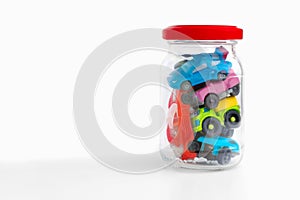 Concept of vehicle maintanence. Automobile insurance. Traffic jam concept. Toy cars in transparent bottle on white