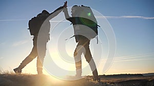 Concept victory teamwork achievement goal slow motion video business concept. two tourists meet on top of a mountain