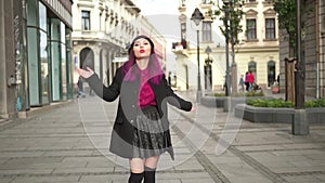 Concept of vogue and hipster lifestyle. Attractive fashionable young woman walking in a beautiful street. Portrait of