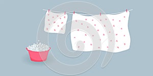 Concept of washing and drying: washed cute white bed sheet and pillowcase with pink hearts.Linen hanging on clothesline and it is