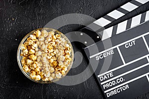 Concept of watching movies with popcorn top view dark background