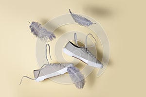 The concept of weightlessness and lightness. sneakers float in the air with flying feathers