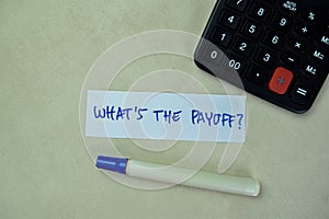 Concept of What\'s The Payoff? write on sticky notes isolated on Wooden Table