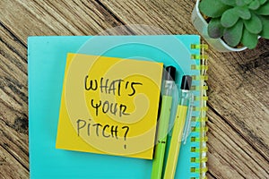Concept of What\'s Your Pitch? write on sticky notes isolated on Wooden Table