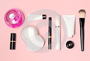 Concept of a white and black cosmetic supplies. Top view on pink background