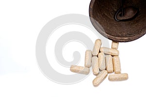 Concept for whom the bell tolls: old antique bell and medical pills isolated on white
