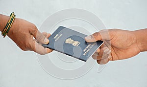 Concept of woemn receving passport at the door step of the house in India