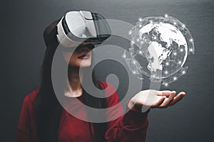 Concept of woman wearing VR glasses .Communication technology and internet worldwide for business concept.Woman hand holding