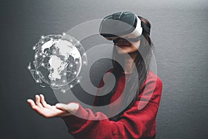 Concept of woman wearing VR glasses .Communication technology and internet worldwide for business concept.Woman hand holding