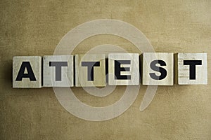 Concept of The wooden Cubes with the word Attest on wooden background