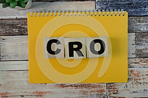 Concept of The wooden Cubes with the word CRO - Conversion Rate Optimization on wooden background