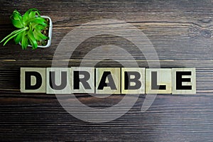 Concept of The wooden Cubes with the word Durable on wooden background