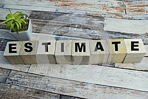 Concept of The wooden Cubes with the word Estimate on wooden background